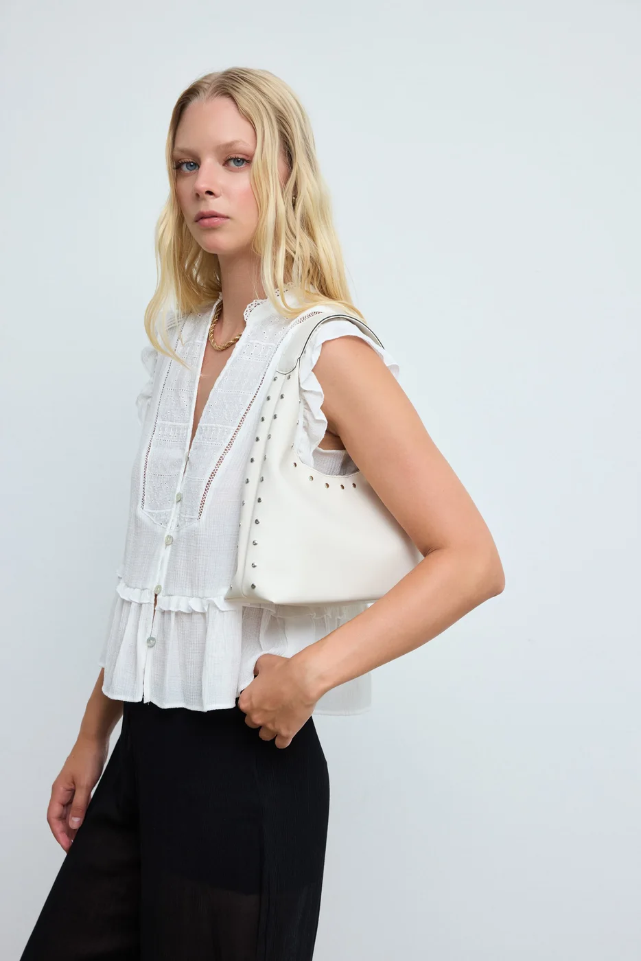 Faux leather shoulder bag with stylish design in cream