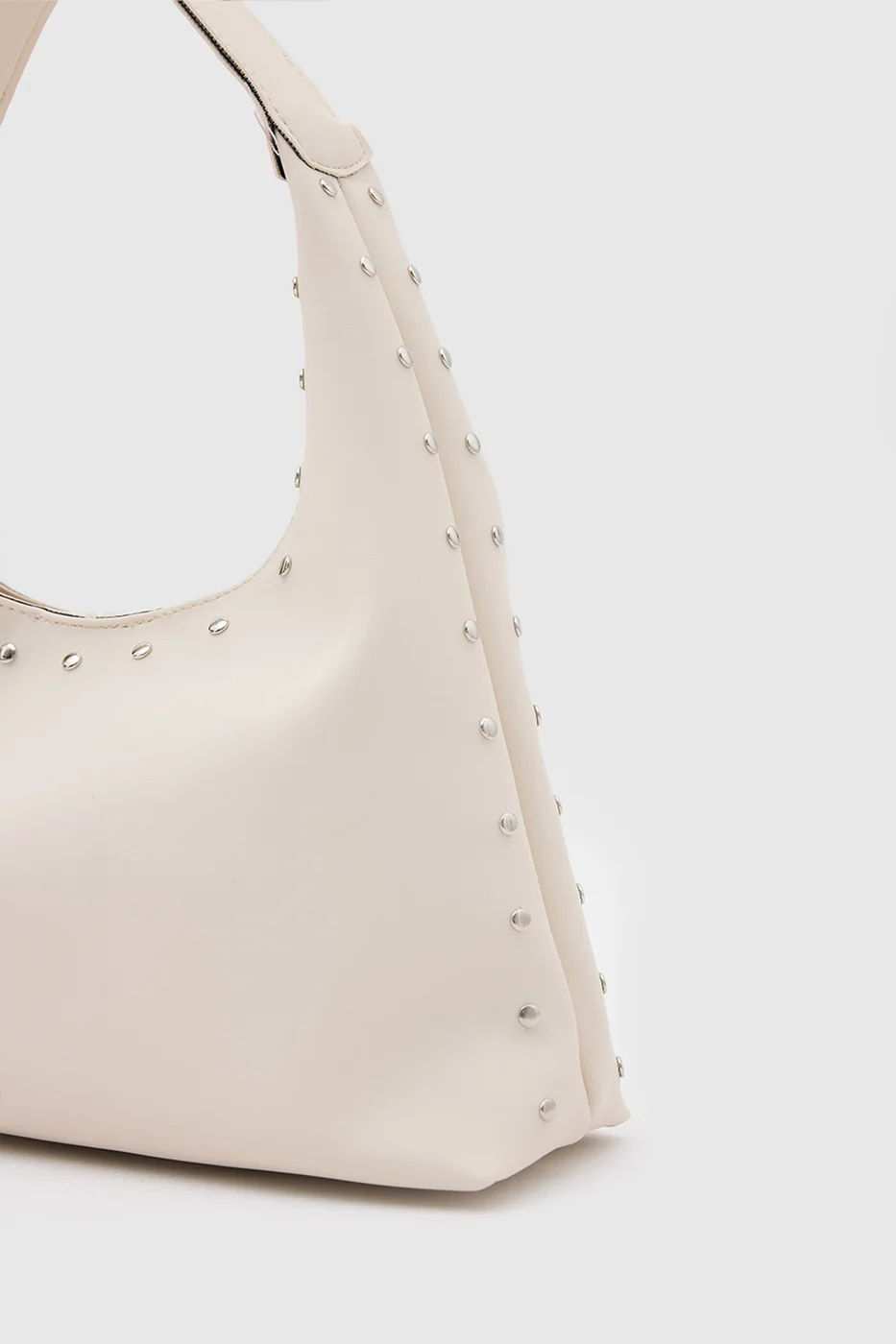 Faux leather shoulder bag with stylish design in cream