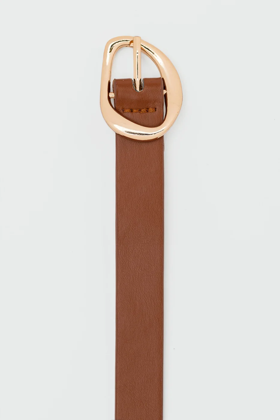 Faux leather belt with asymmetrical buckle Faux leather belt with asymmetrical buckle in tan