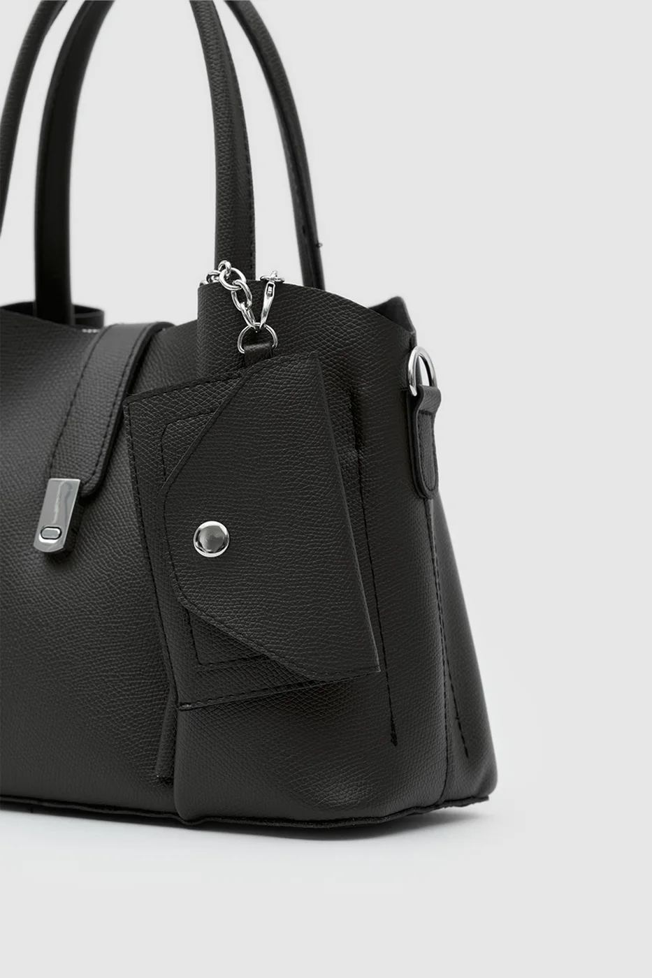 Faux leather shoulder bag with charm in black
