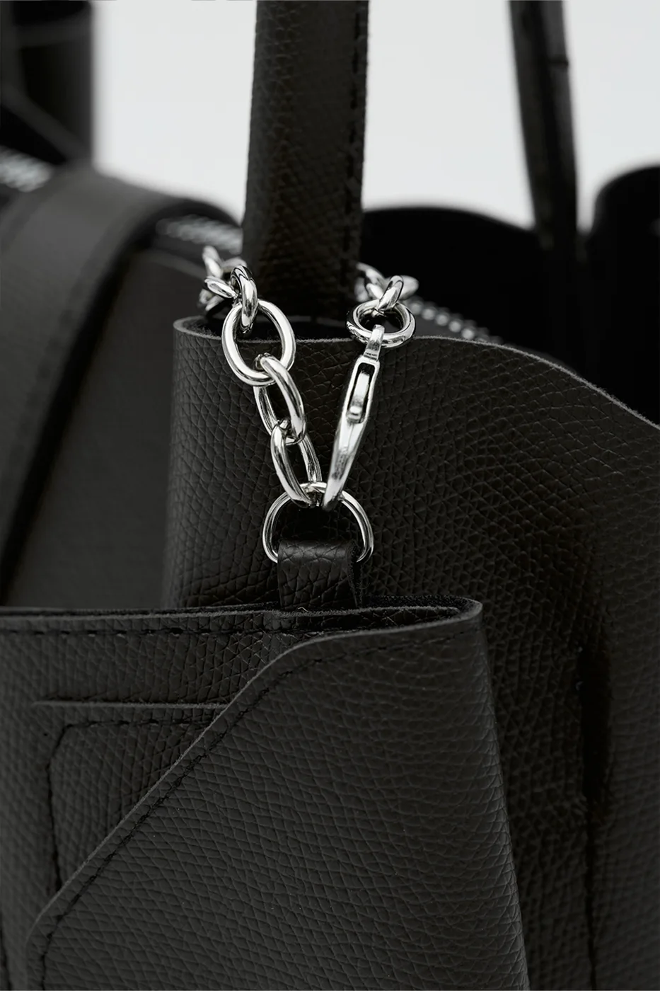 Faux leather shoulder bag with charm in black