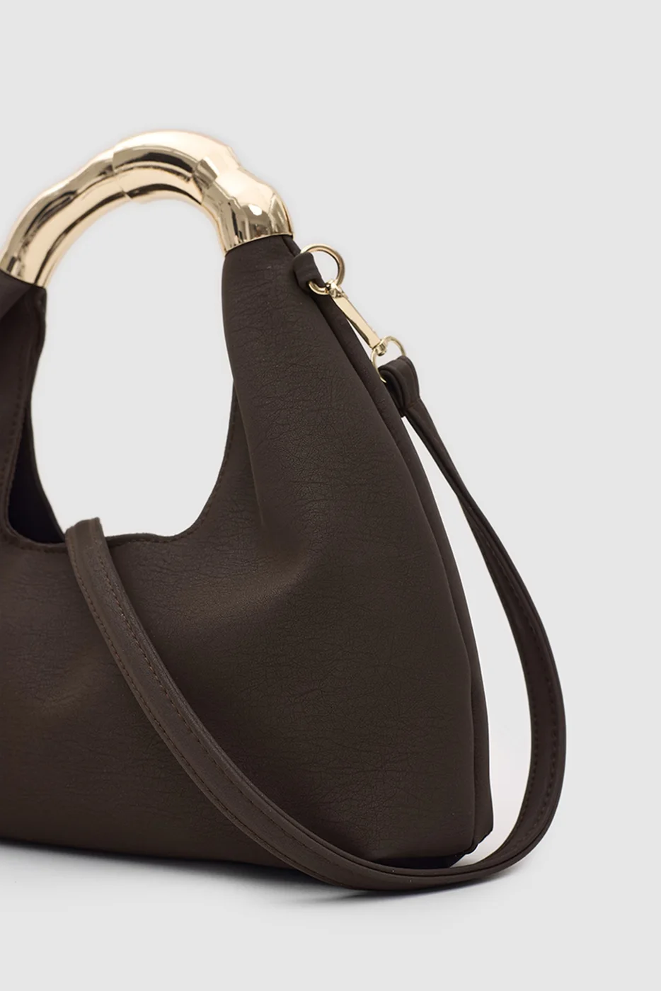 Faux leather shoulder bag with gold accents Faux leather shoulder bag with gold accents in dark brown