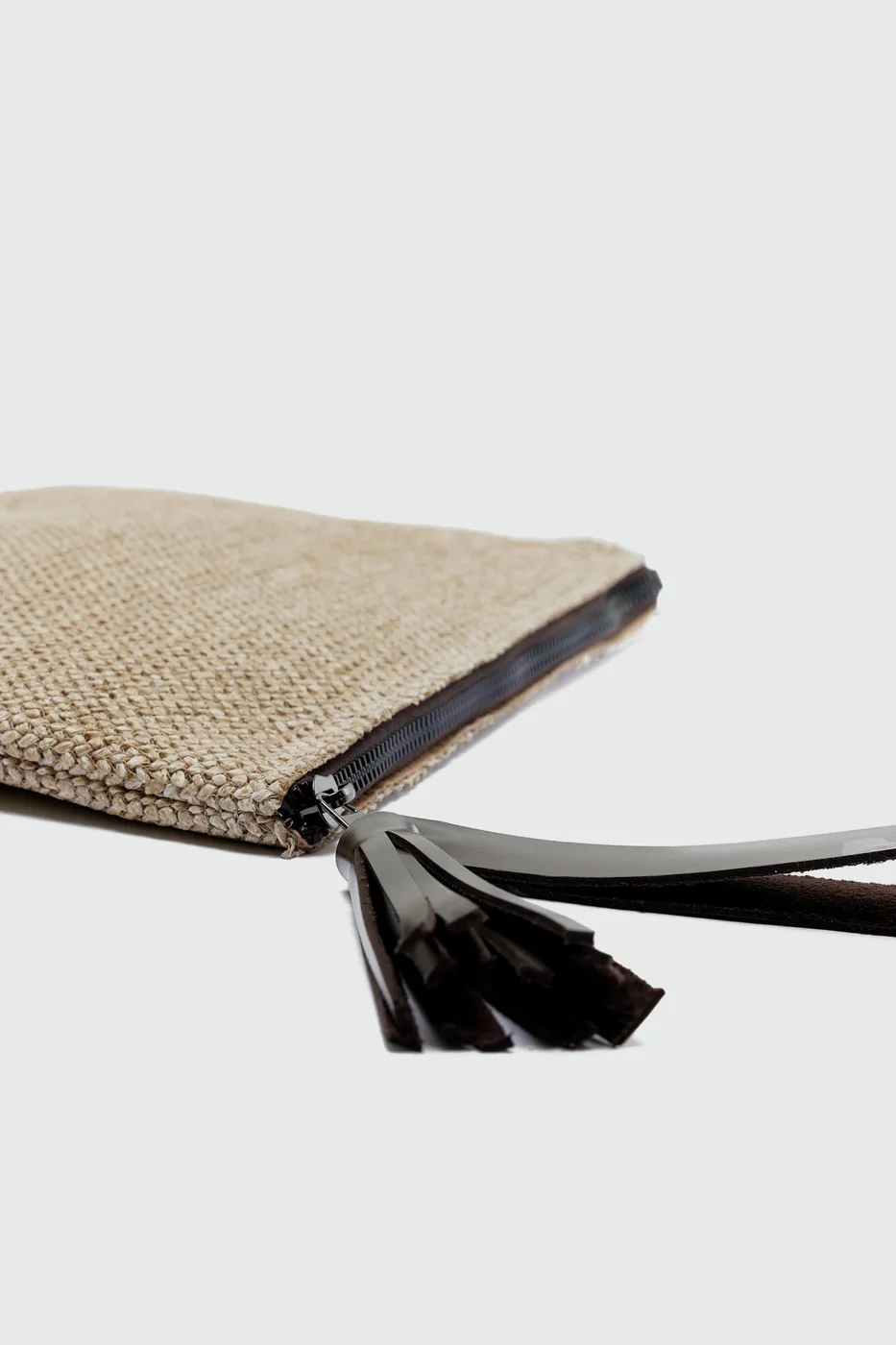 Woven clutch bag with fringe detail in brown