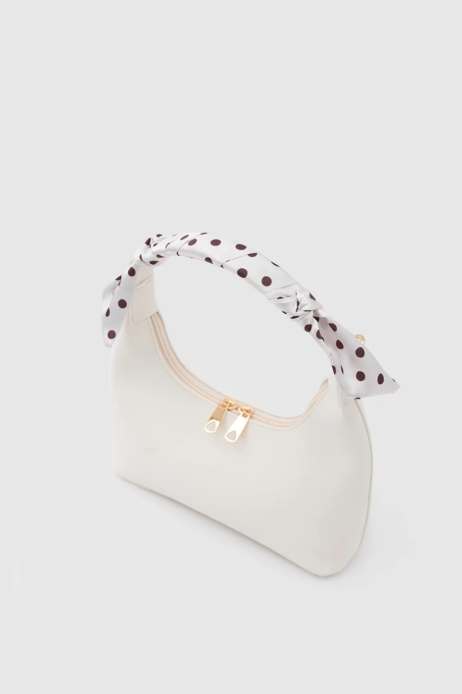 Faux leather crossbody bag with stylish design in cream
