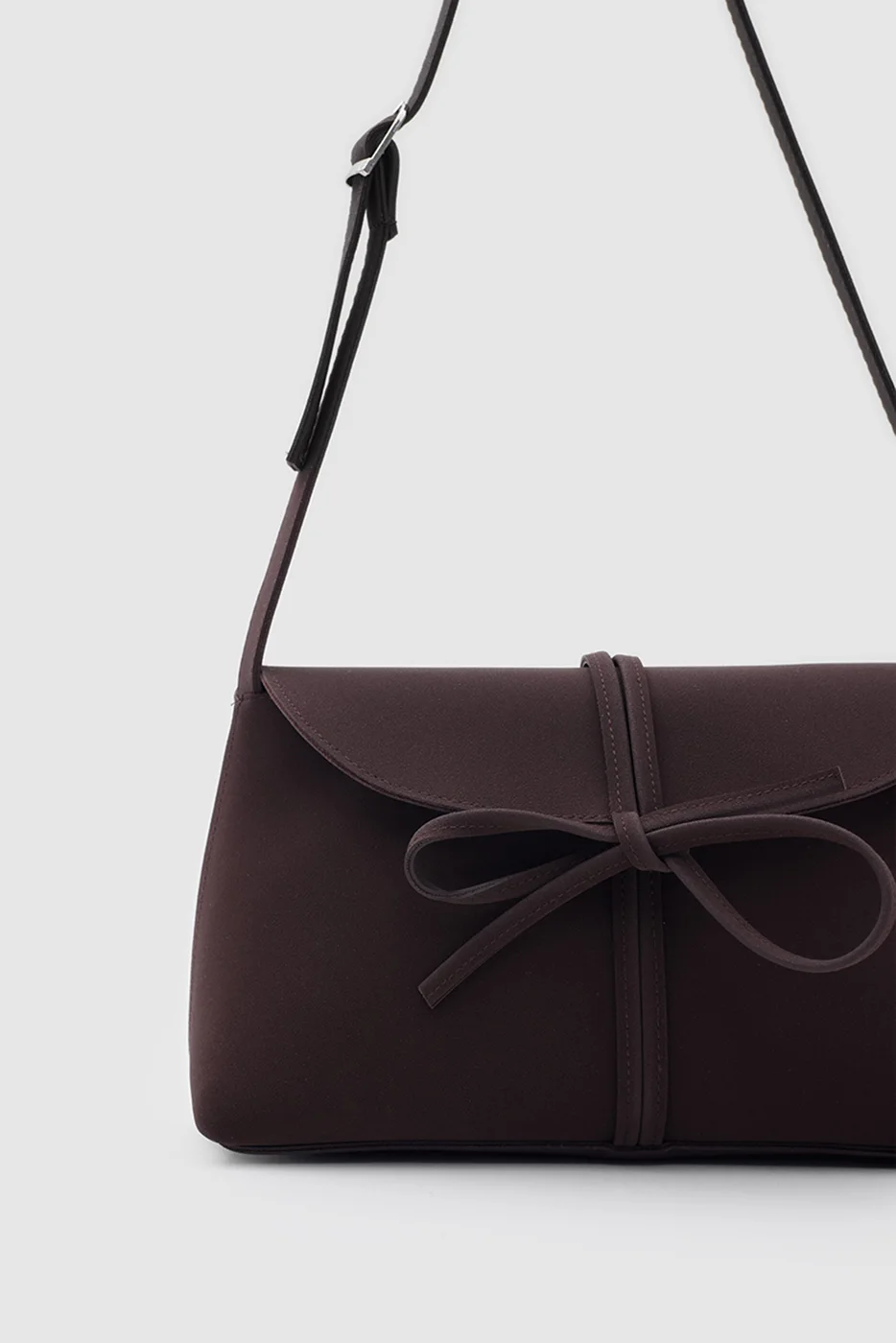 faux suede shoulder bag with bow in dark brown