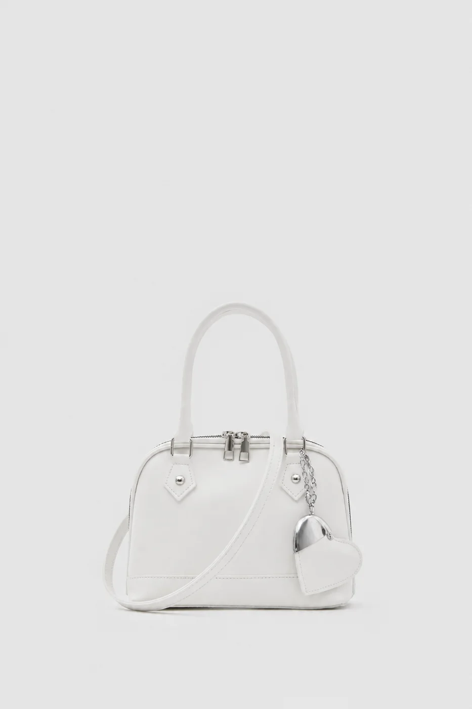 Faux leather crossbody bag with heart charm Faux leather crossbody bag with heart charm in cream