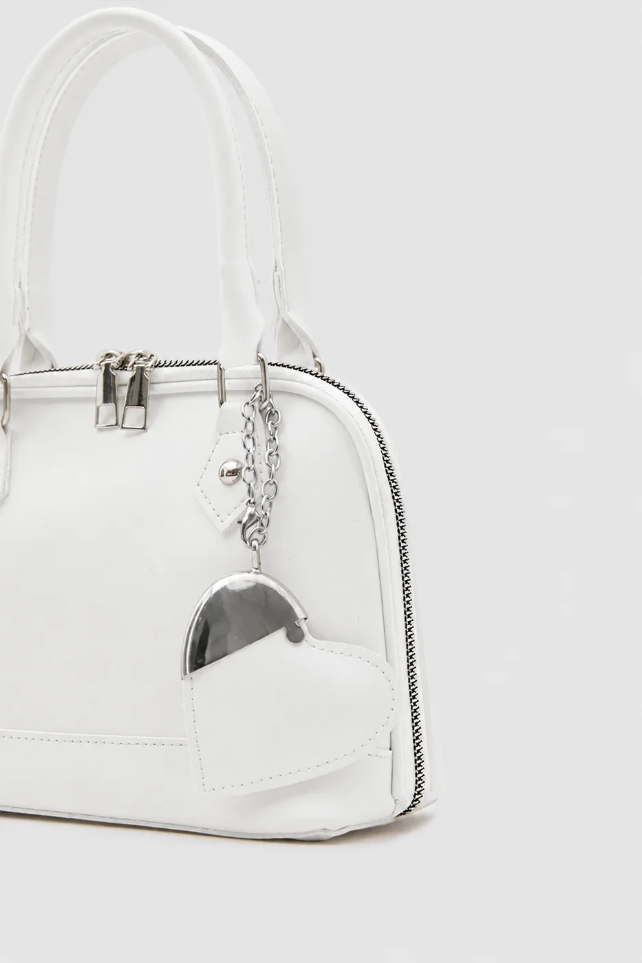 Faux leather crossbody bag with heart charm Faux leather crossbody bag with heart charm in cream