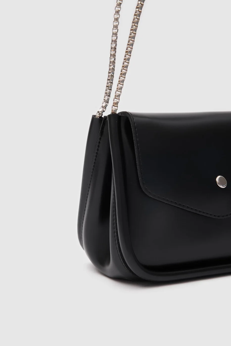 Faux leather crossbody bag with chain details Faux leather crossbody bag with chain details in black